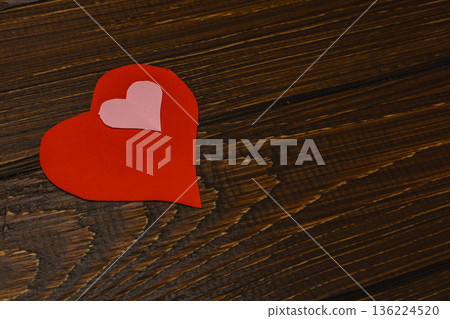 Crafting a red heart shape on a wooden table for decoration Crafting a red heart shape on a wooden table for decoration 136224520