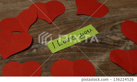 Heart shapes and a message on a wooden surface Heart shapes and a message on a wooden surface 136224526