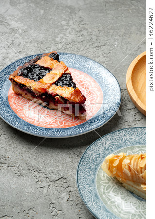 Sliced berry dessert served on plates with simple design in a casual setting Sliced berry dessert served on plates with simple design in a casual setting 136224622