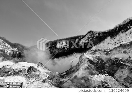 Steam rising from fumaroles on the rugged mountainside, "Noboribetsu Jigokudani" in black and white 136224699