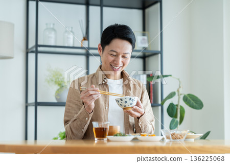 Middle-aged man eating breakfast Middle-aged man eating breakfast 136225068