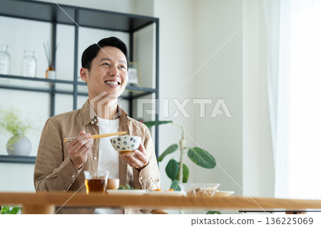 Middle-aged man eating breakfast Middle-aged man eating breakfast 136225069