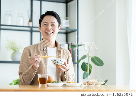Middle-aged man eating breakfast Middle-aged man eating breakfast 136225071