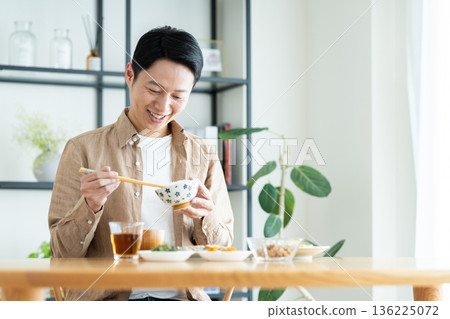 Middle-aged man eating breakfast Middle-aged man eating breakfast 136225072