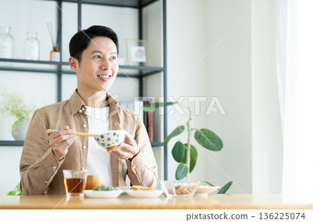 Middle-aged man eating breakfast Middle-aged man eating breakfast 136225074