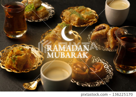 Celebration of Ramadan with traditional sweets and drinks on a festive table in the evening 136225170