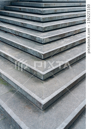 Steps made from gray stone arranged in layers at a park in the afternoon Steps made from gray stone arranged in layers at a park in the afternoon 136225180