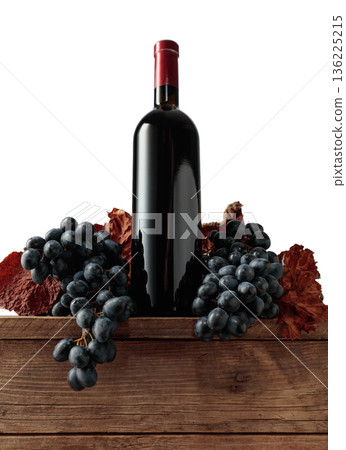 Red wine bottle with blue grapes on an old wooden table. Red wine bottle with blue grapes on an old wooden table. 136225215