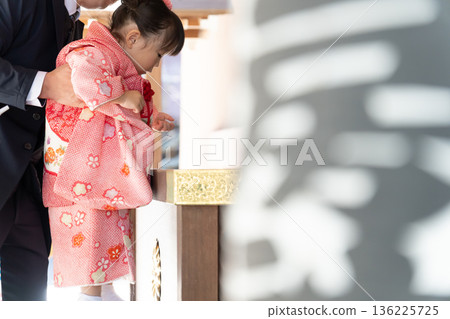 A girl visiting a shrine to celebrate Shichi-Go-San A girl visiting a shrine to celebrate Shichi-Go-San 136225725