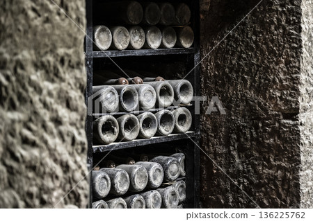 Vintage bottles stored carefully, Ancient wine containers in quiet chamber, Marbled chamber filled with aged wine bottles and cobwebs Vintage bottles stored carefully, Ancient wine containers in quiet chamber, Marbled chamber filled with aged wine bottles and cobwebs 136225762