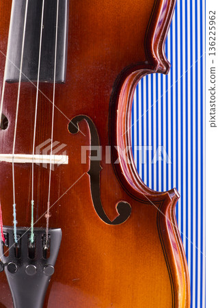 A violin fragment on a blue background 136225962