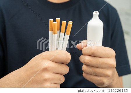 Man holding electronic cigarettes, no smoking. Man holding electronic cigarettes, no smoking. 136226185