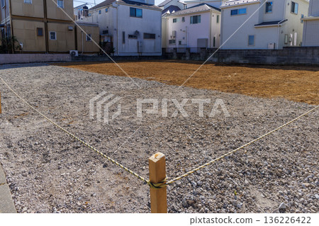 Leveled vacant land in a residential area (housing land development) 136226422