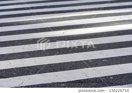White crosswalk line pattern painted on asphalt 136226758