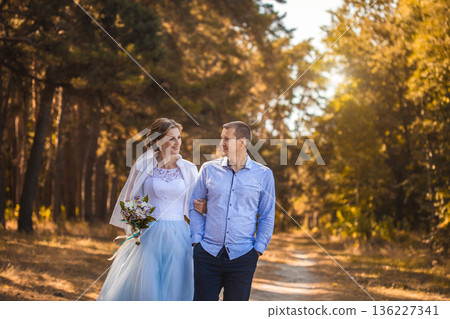 newlyweds are walking in the green Pine forest newlyweds are walking in the green Pine forest 136227341