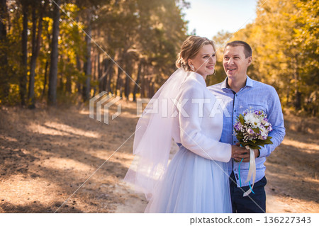 newlyweds are walking in the green Pine forest newlyweds are walking in the green Pine forest 136227343