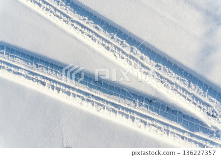 car tire tracks on the snow 136227357
