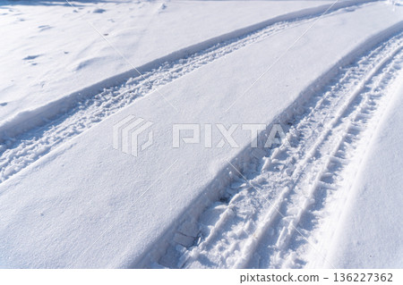 car tire tracks on the snow 136227362