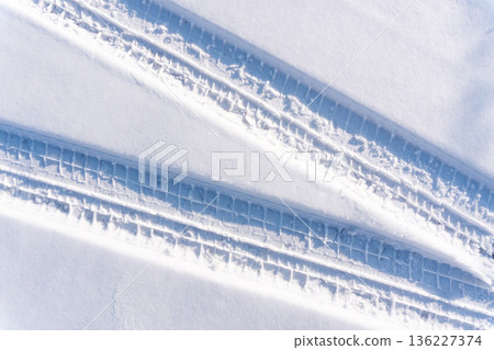 car tire tracks on the snow 136227374