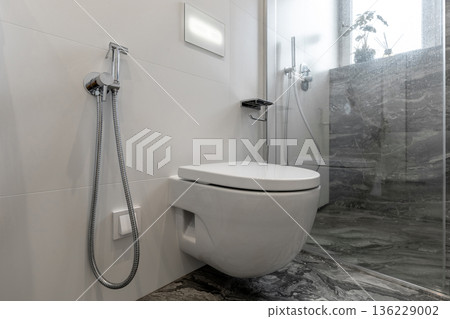 Modern Bathroom Interior with Wall Hung Toilet and Marble Tiles Modern Bathroom Interior with Wall Hung Toilet and Marble Tiles 136229002