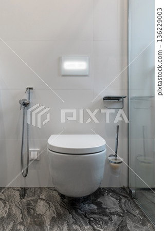 Modern Bathroom with Wall-Mounted Toilet and Dark Marble Floor Modern Bathroom with Wall-Mounted Toilet and Dark Marble Floor 136229003