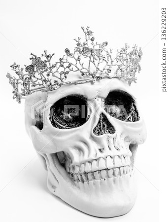 Human Skull with Silver Crown on White Background 136229203