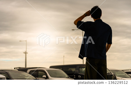 A man gazing into the distance in a parking lot. Photo courtesy of Kansai International Airport (KIX) A man gazing into the distance in a parking lot. Photo courtesy of Kansai International Airport (KIX) 136229512
