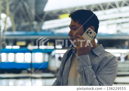 A man making a phone call at a futuristic train station. Photo courtesy of Kansai International Airport (KIX). A man making a phone call at a futuristic train station. Photo courtesy of Kansai International Airport (KIX). 136229555