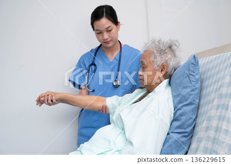 Asian doctor checking and treat elderly woman patient health in hospital. Asian doctor checking and treat elderly woman patient health in hospital. 136229615