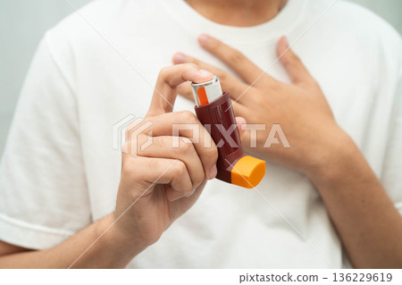 Asthma and chronic obstructive pulmonary disease COPD, Asian teenage using metered dose inhaler MDI. Asthma and chronic obstructive pulmonary disease COPD, Asian teenage using metered dose inhaler MDI. 136229619
