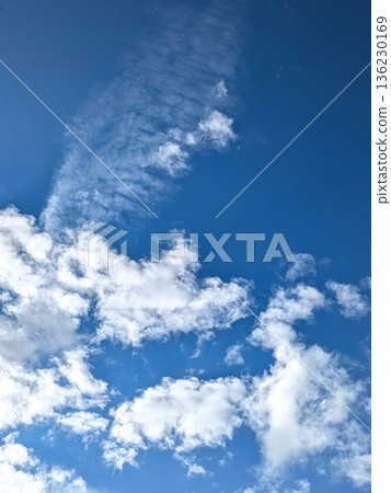 White fluffy clouds on a beautiful clear blue sky White fluffy clouds on a beautiful clear blue sky 136230169