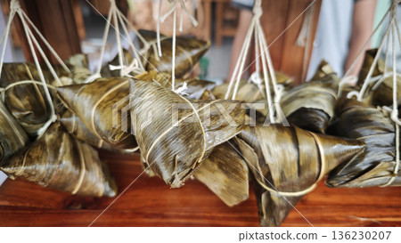 Zongzi, an ancient Chinese traditional dish wrapped in fragrant leaves, crafted with fine ingredients and cherished in cultural festival rituals. 136230207