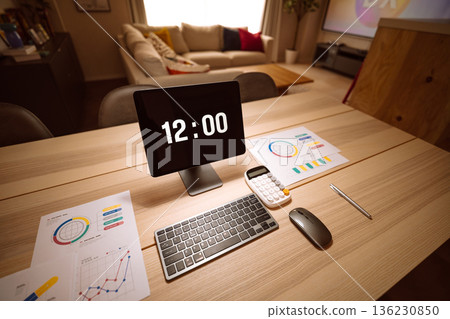 Digital clock and documents on a desk 136230850