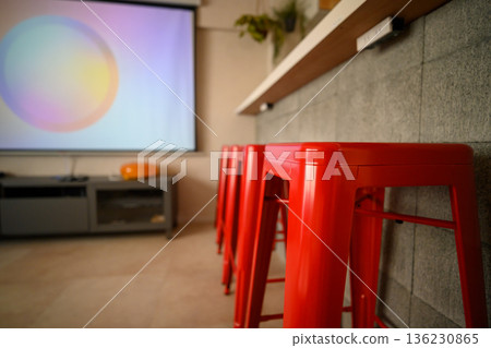 Red high stool and projector 136230865