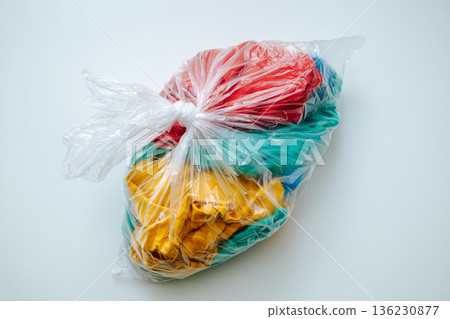 Clothes in a plastic bag 136230877