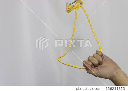 A man's hand holding a looped rope hanging from above (faceless, Japanese, 30s) 136231853
