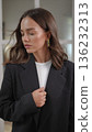 Elegant businesswoman with brown hair looking into the camera 136232313