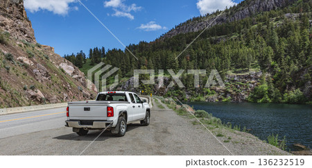 Pickup truck on the beautiful road along the mountain river and forest. Pickup truck on the beautiful road along the mountain river and forest. 136232519