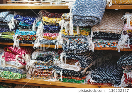 A collection of rag rugs handmade with a traditional loom at a street marketplace - no people A collection of rag rugs handmade with a traditional loom at a street marketplace - no people 136232527