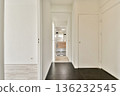 A sleek and modern hallway showcasing minimalist design elements. The space features a clear view into a stylish bathroom with clean lines and neutral colors. 136232545