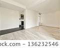 A bright and spacious modern interior featuring clean lines, minimalist decor, and natural light streaming through large windows. 136232546