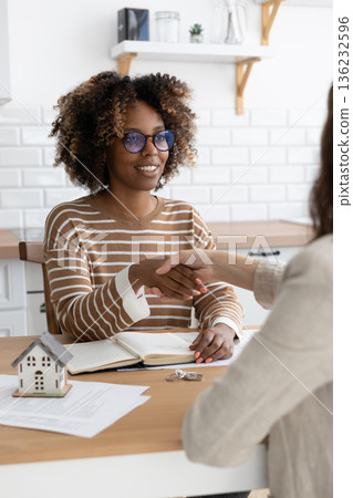 handshake between two people, conclusion of contract for sale of real estate. 136232596