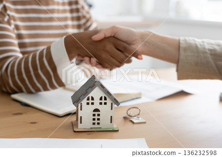 handshake between two people, conclusion of contract for sale of real estate. handshake between two people, conclusion of contract for sale of real estate. 136232598
