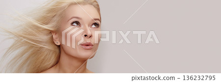 Blonde Woman Beauty Portrait WindSwept Hair, Upward Gaze, Soft Studio Lighting, Flawless Skin, Natural Makeup, Motion Captured In Strands, Editorial Glamour Vibe, Confident, Blond Hair Style, Bleach 136232795