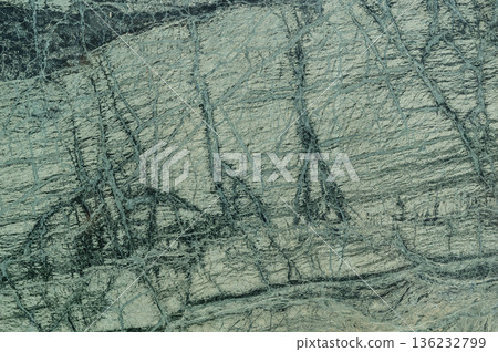 Natural green granite stone surface with dark mineral veins Natural green granite stone surface with dark mineral veins 136232799