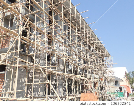 Thai construction site: Bamboo scaffolding and buildings under construction Thai construction site: Bamboo scaffolding and buildings under construction 136232841