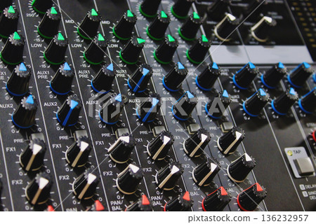 Close-up shot of rows of control knobs and buttons on a digital multi effect processor unit - professional mix technology for the music industry Close-up shot of rows of control knobs and buttons on a digital multi effect processor unit - professional mix technology for the music industry 136232957