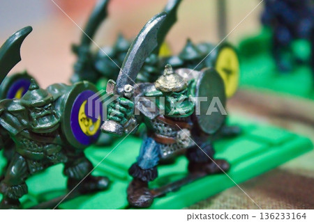 Close-up macro shot of a band of green ogres or orcs, plastic miniatures monsters for a strategy boardgame Close-up macro shot of a band of green ogres or orcs, plastic miniatures monsters for a strategy boardgame 136233164