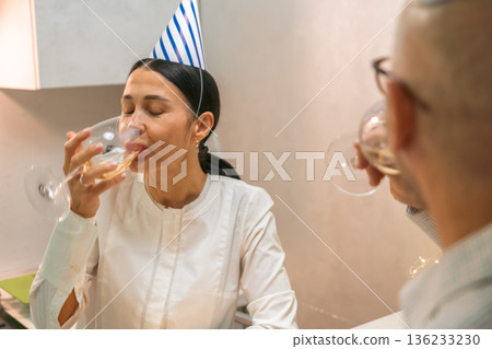 Birthday Party Woman Drinking Wine Celebration: Indoors, present-day, joyful occasion. 136233230