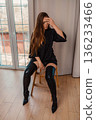 Woman boots fashion posing indoors wearing black robe and high heels. 136233466